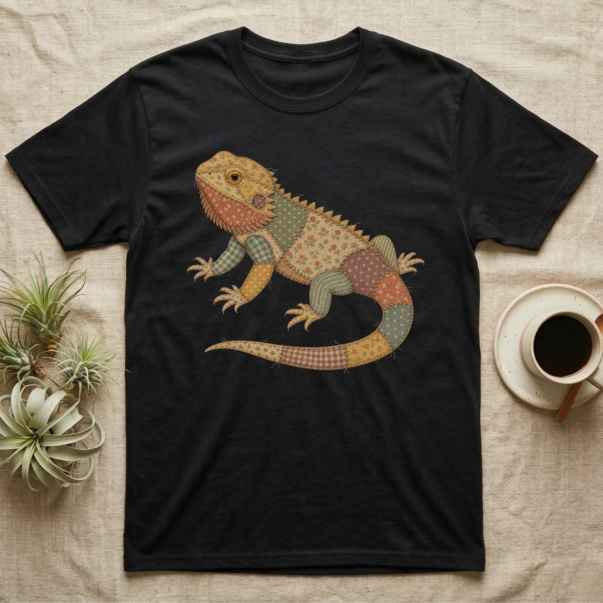 Black t-shirt featuring a patchwork lizard graphic.