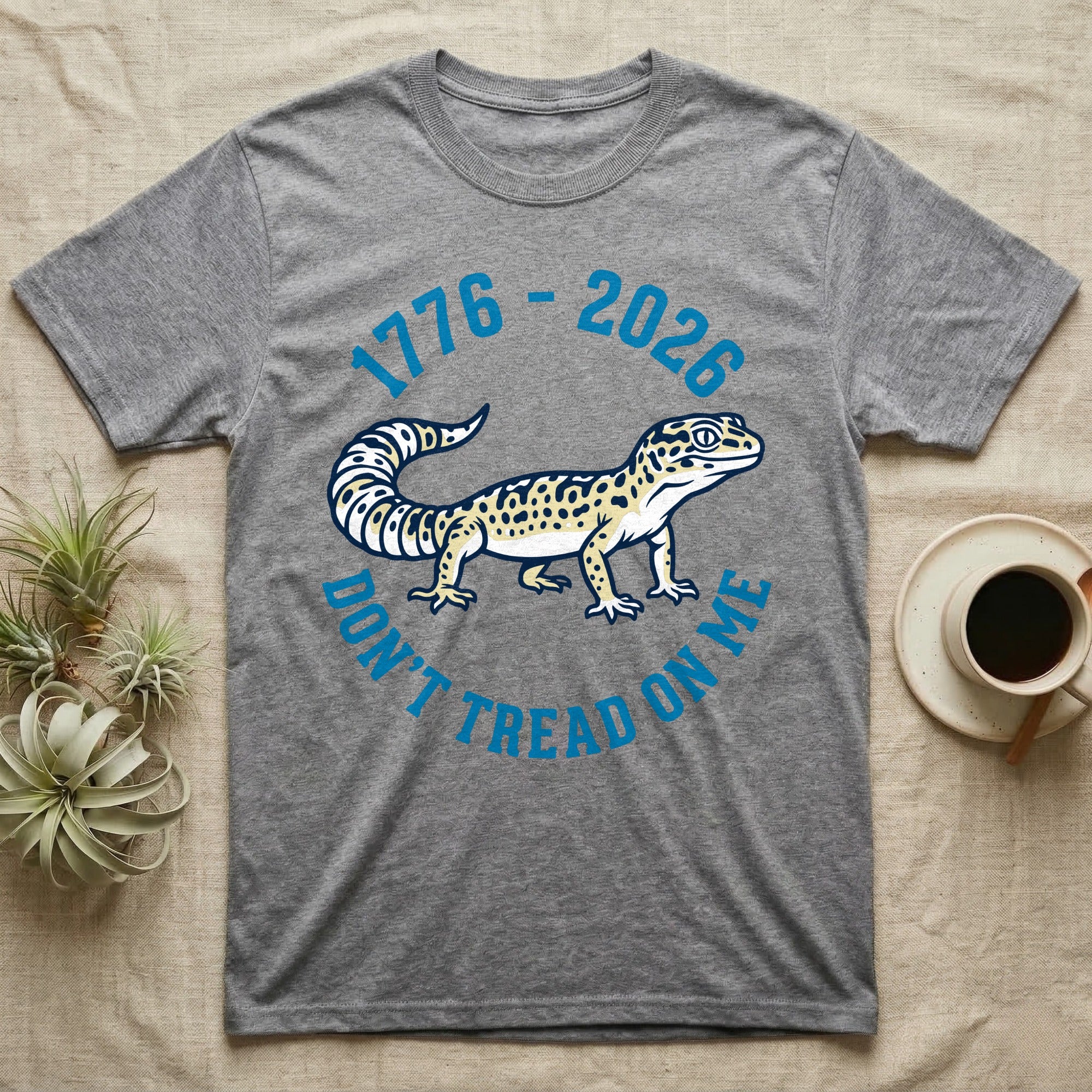 Leopard Gecko 1776 T-Shirt in Sport Grey — Two-colour vector leopard gecko in profile ringed by arched text reading 1776 to 2026 and Don't Tread On Me.