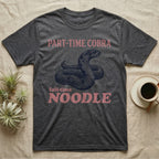 Hognose Snake Noodle T-Shirt in Dark Heather — Navy engraving of a coiled western hognose snake bluffing with a flattened neck between the words PART-TIME COBRA and full-time NOODLE in rose