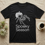 Jumping Spider Spooky Season T-Shirt in Black — Minimal continuous-line jumping spider over a spiderweb pumpkin, text "Spooky Season" with a spider in the O.