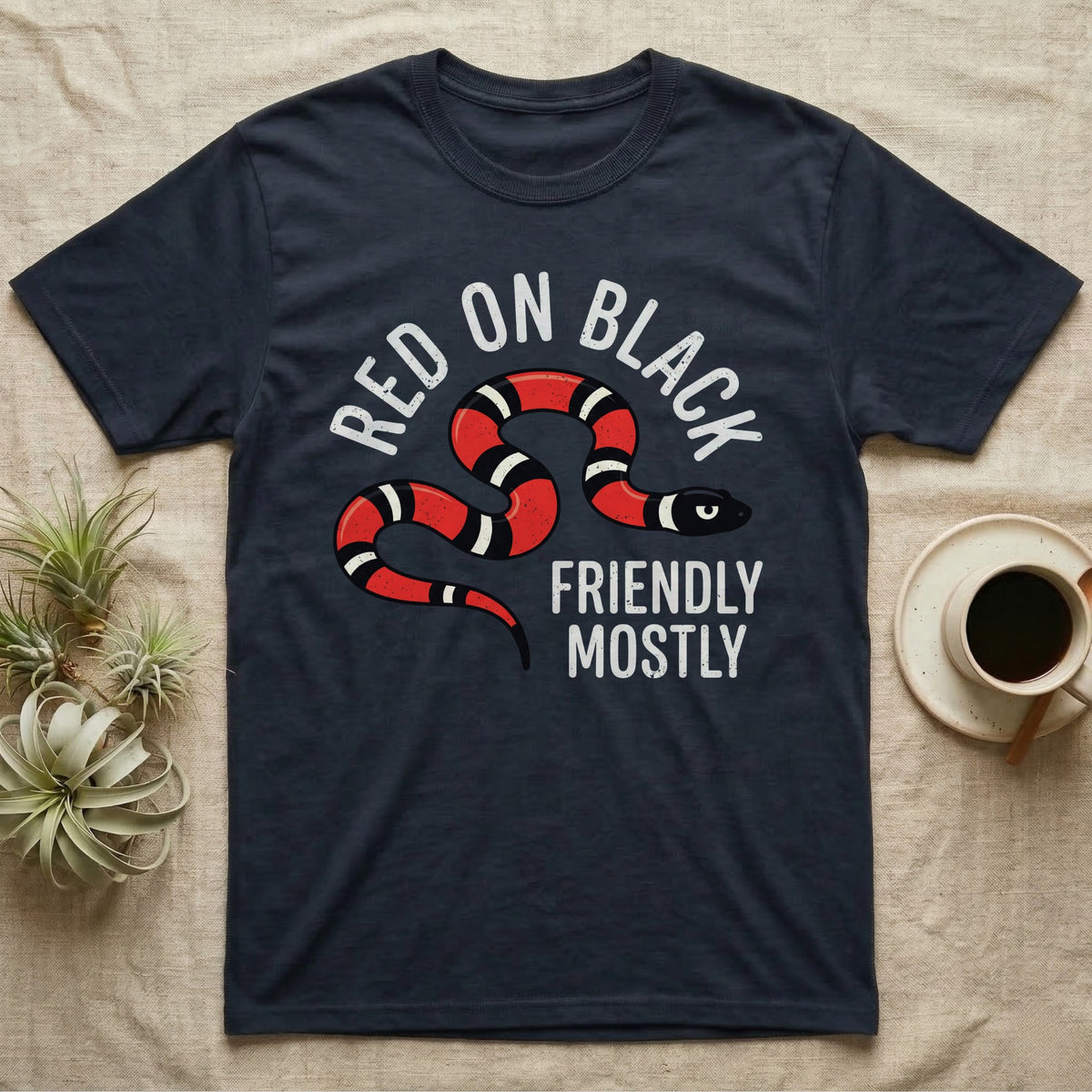 Milk Snake Friendly T-Shirt in Navy — Worn screen-print of a red, black and cream banded milk snake under the cream words Red On Black, Friendly, Mostly