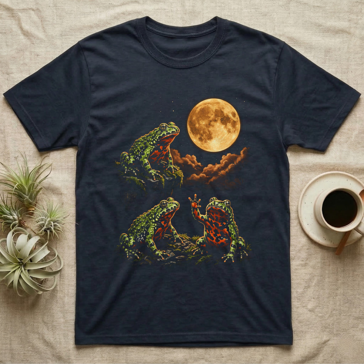 Fire-Bellied Toad Moon T-Shirt in Navy — Three fire-bellied toads under a glowing amber full moon, one on a mossy ledge, one reaching a front foot up at the moon