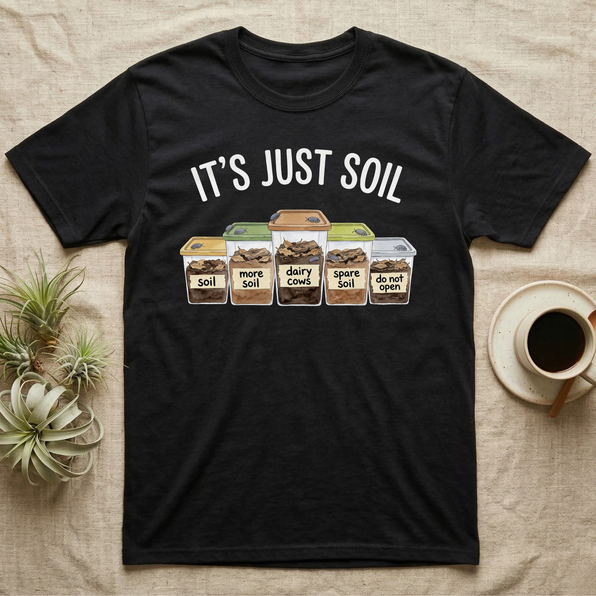 Isopod Soil Bins T-Shirt in Black — Watercolour row of five labelled bins of soil with isopods on the lids under the words IT'S JUST SOIL