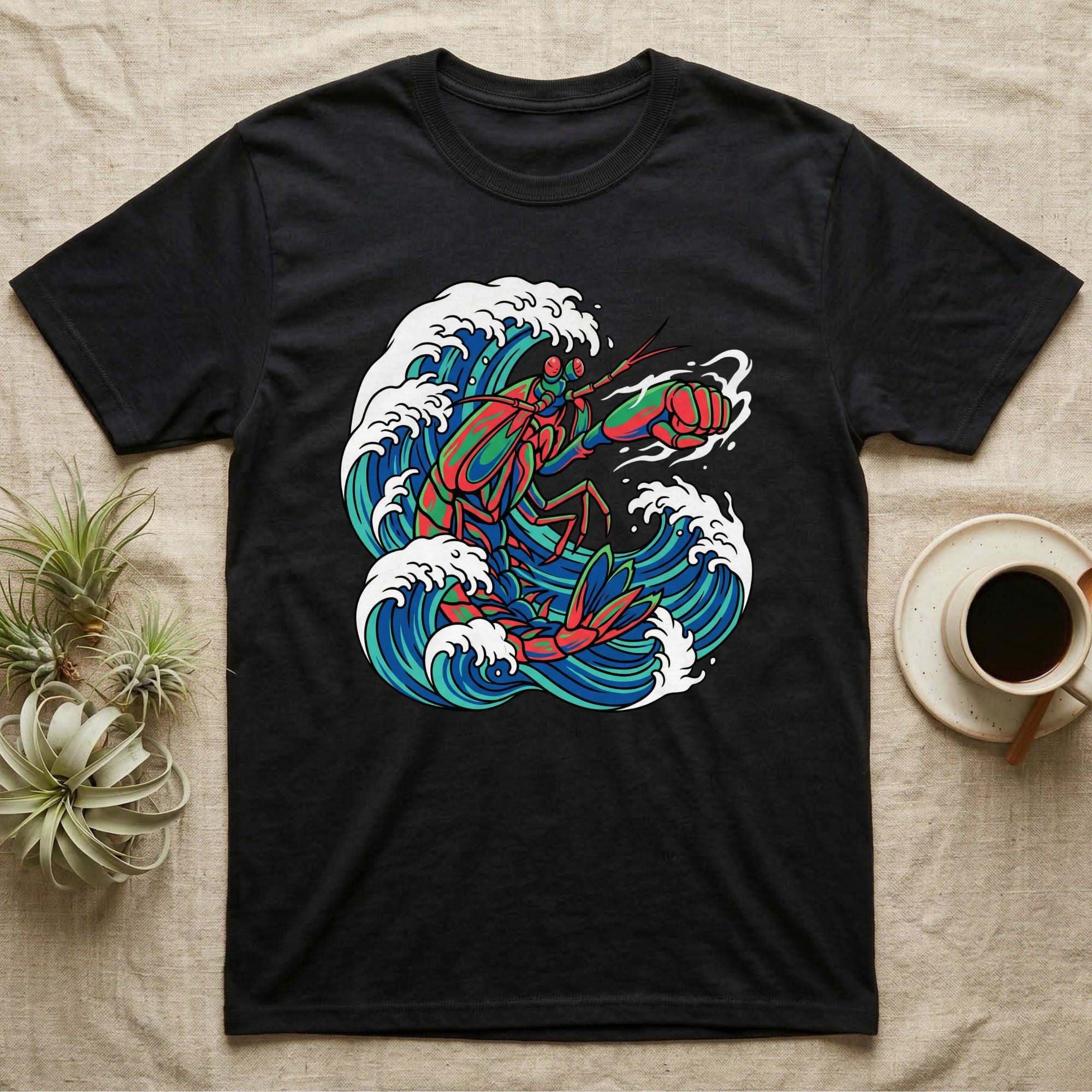 Black t-shirt with colorful lobster and ocean waves graphic.
