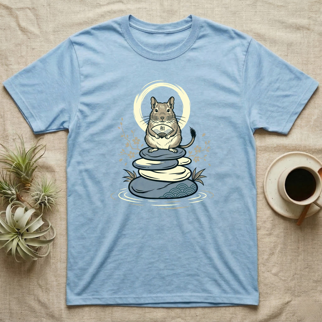 Light blue t-shirt with a tan degu meditating on stacked stones and a sunburst.