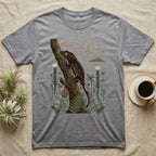 Crested Gecko Home Range T-Shirt in Sport Grey — Woodcut-style illustration of a crested gecko clinging head-up to a mossy rainforest trunk among tree ferns, no on-shirt text.