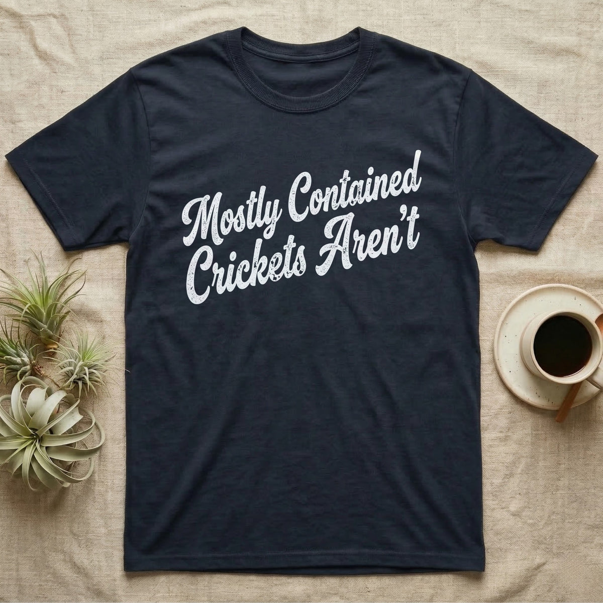 Reptile Cricket Escape T-Shirt in Navy — Distressed off-white 1970s brush script reading Mostly Contained, Crickets Aren't, climbing a diagonal on charcoal grey