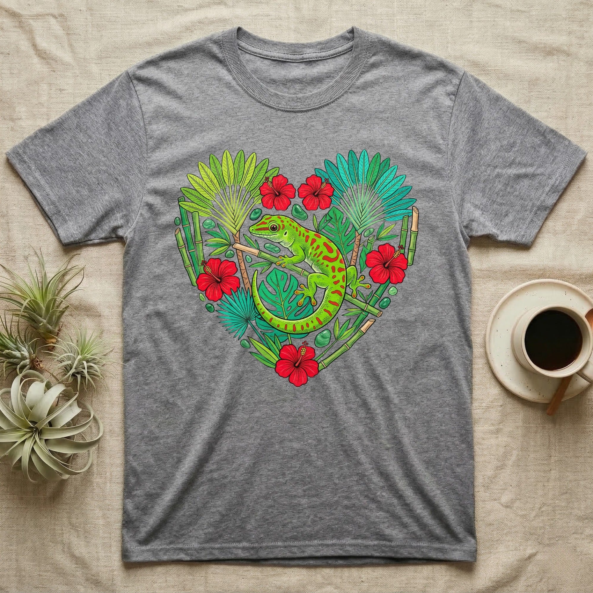 Gray t-shirt with a green gecko and tropical leaves in a heart shape.