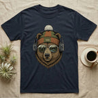 Bear wearing headphones and beanie, with a forest reflection in sunglasses.