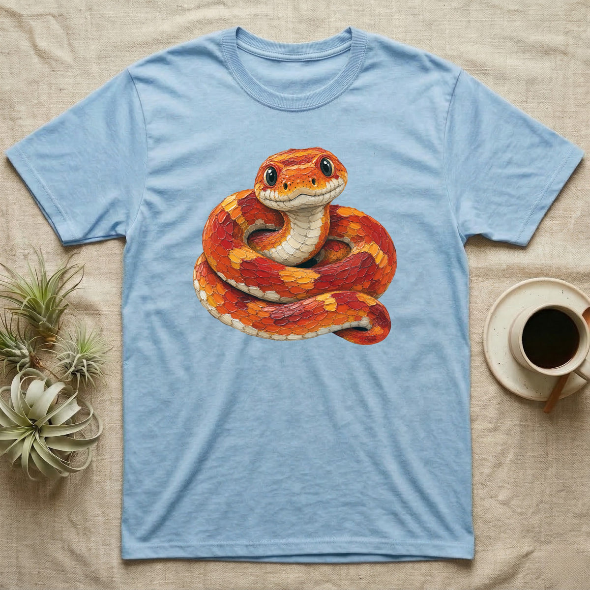 Light blue t-shirt featuring a coiled orange and yellow corn snake illustration.