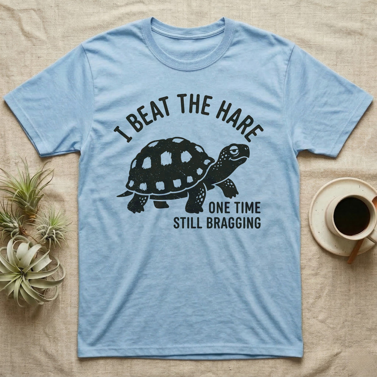 Red-Foot Tortoise Bragging T-Shirt in Light Blue — Smug red-footed tortoise walking chin-up under I Beat the Hare, One Time, Still Bragging