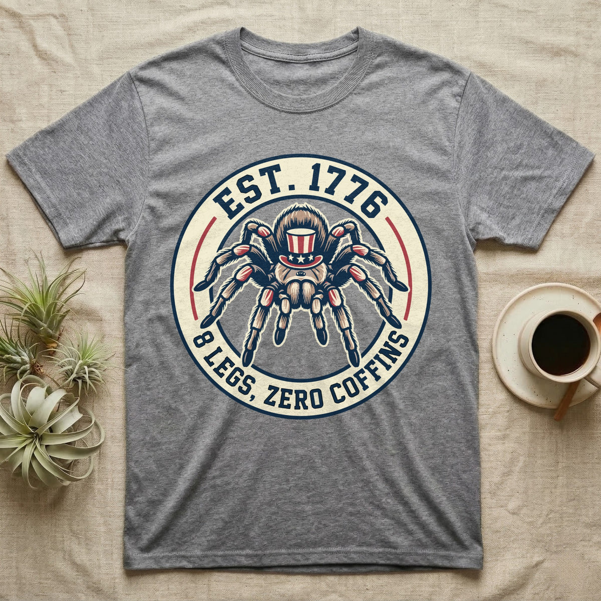 Tarantula Zero Coffins T-Shirt in Sport Grey — Circular patch emblem of a tarantula in a top hat with arched text Est. 1776 and 8 Legs Zero Coffins.