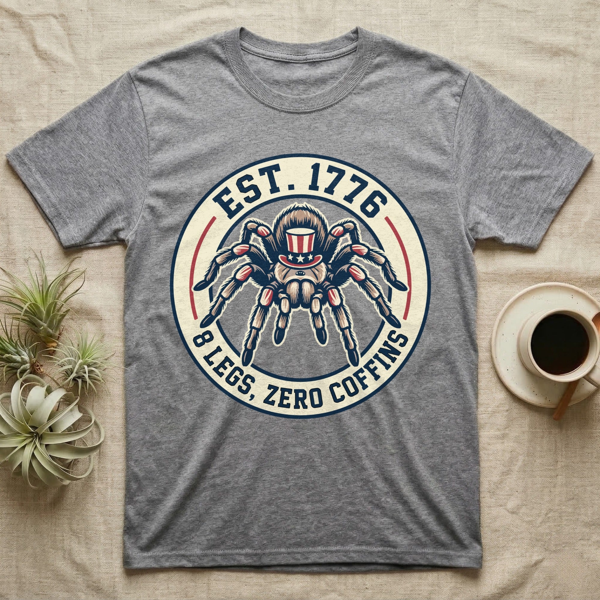 Tarantula Zero Coffins T-Shirt in Sport Grey — Circular patch emblem of a tarantula in a top hat with arched text Est. 1776 and 8 Legs Zero Coffins.