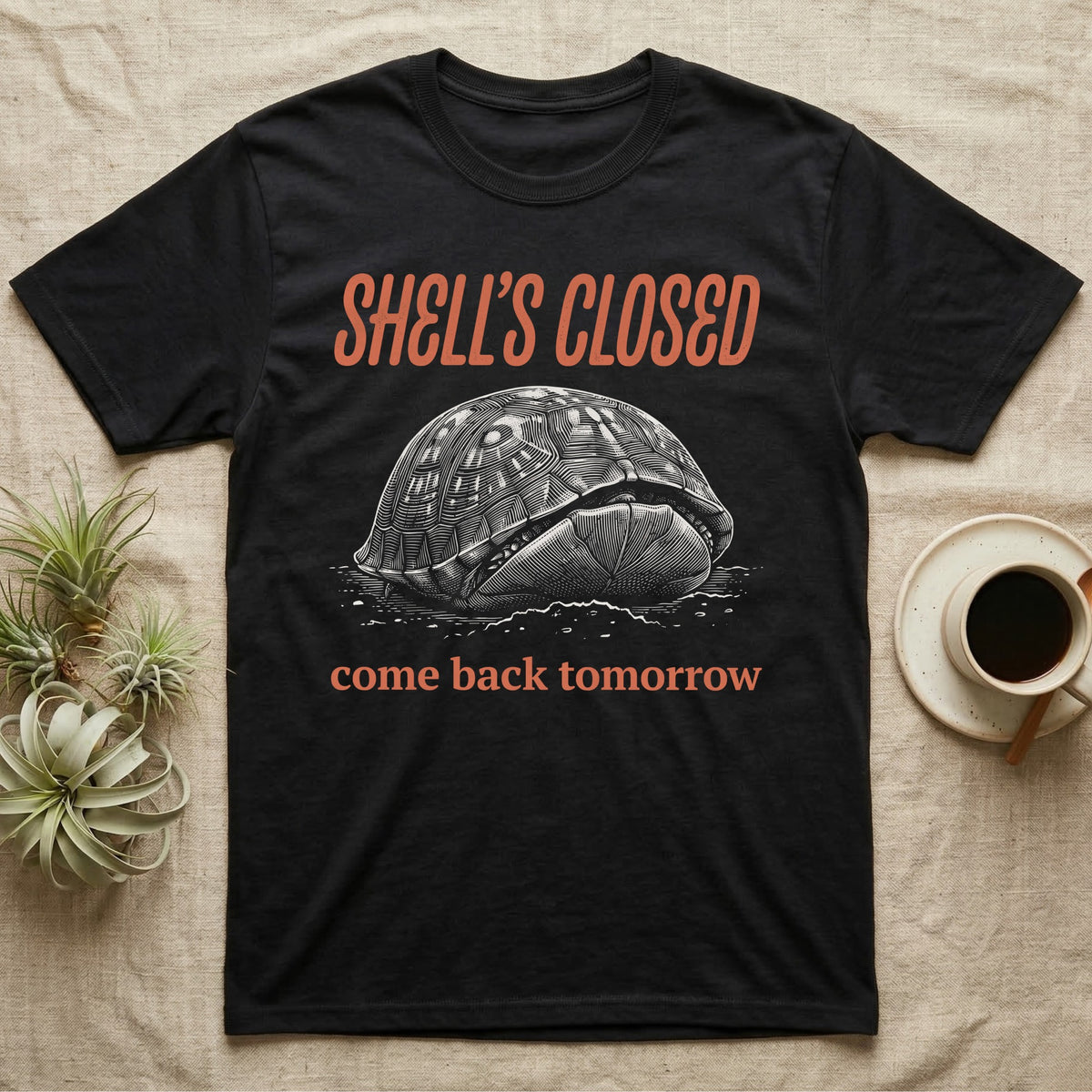Box Turtle Shell's Closed T-Shirt in Black — Engraved white-line eastern box turtle shut tight under retro orange script reading SHELL'S CLOSED, come back tomorrow.