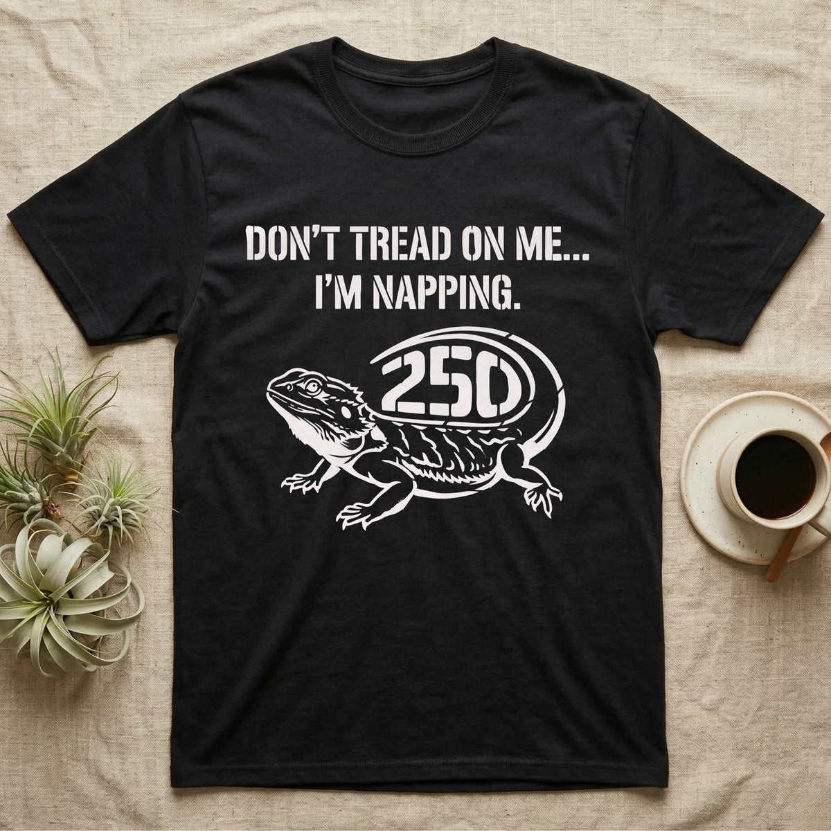 Bearded Dragon Napping T-Shirt in Black — White stencil bearded dragon resting with 250 cut into the tail under text Don't Tread On Me, I'm Napping.