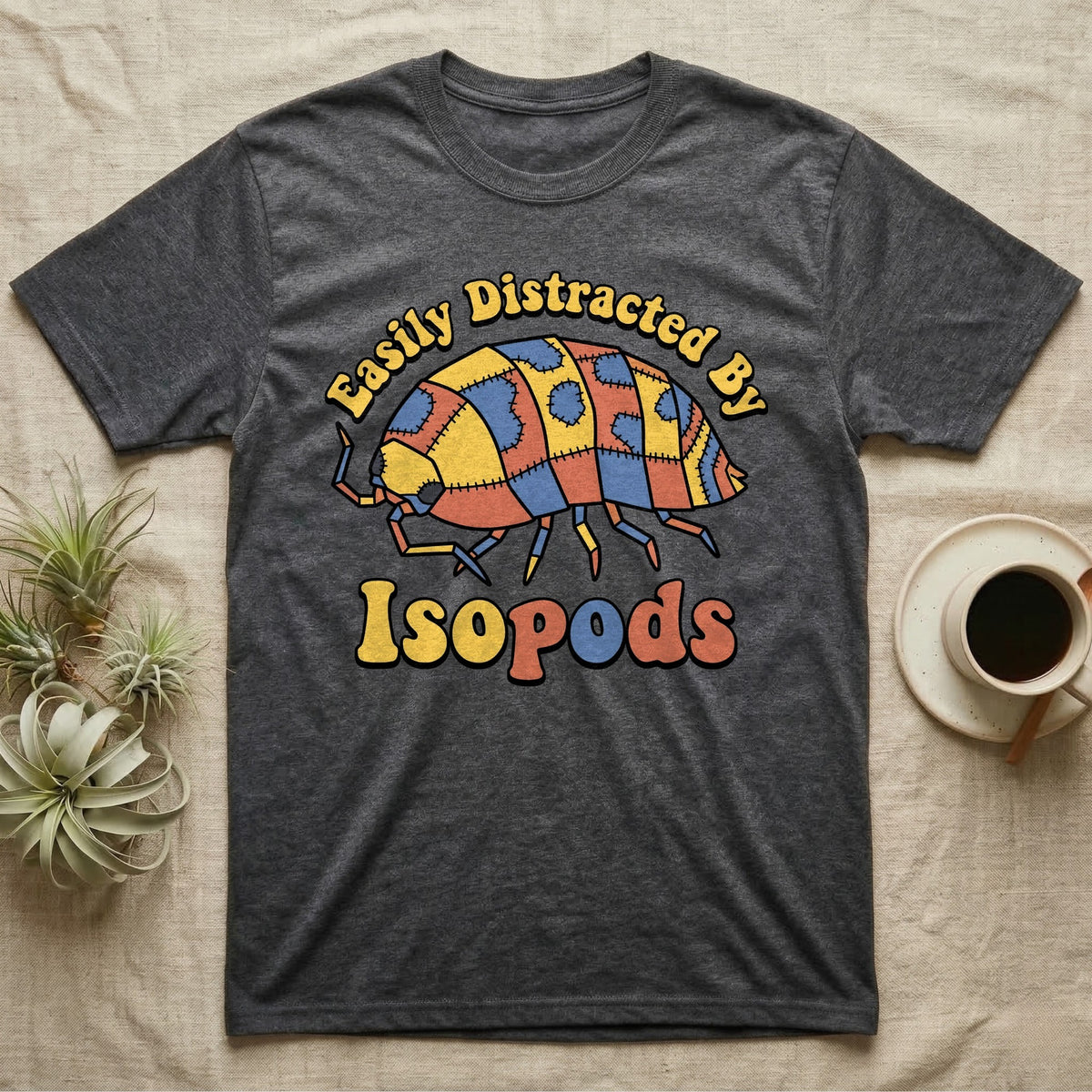 Dairy Cow Isopod Patchwork T-Shirt in Dark Heather — Quilt-patchwork dairy cow isopod in mustard and denim under retro "Easily Distracted By Isopods" text.