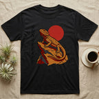 Black t-shirt with a bearded dragon on a rock with a red sun.