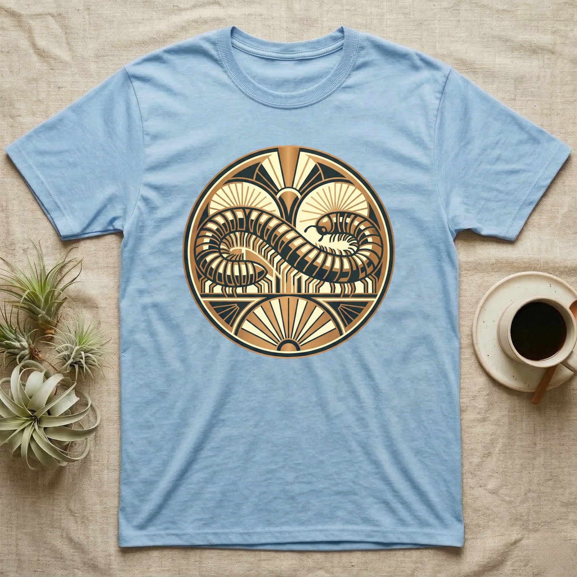 Light blue t-shirt with circular centipede design in gold and brown.