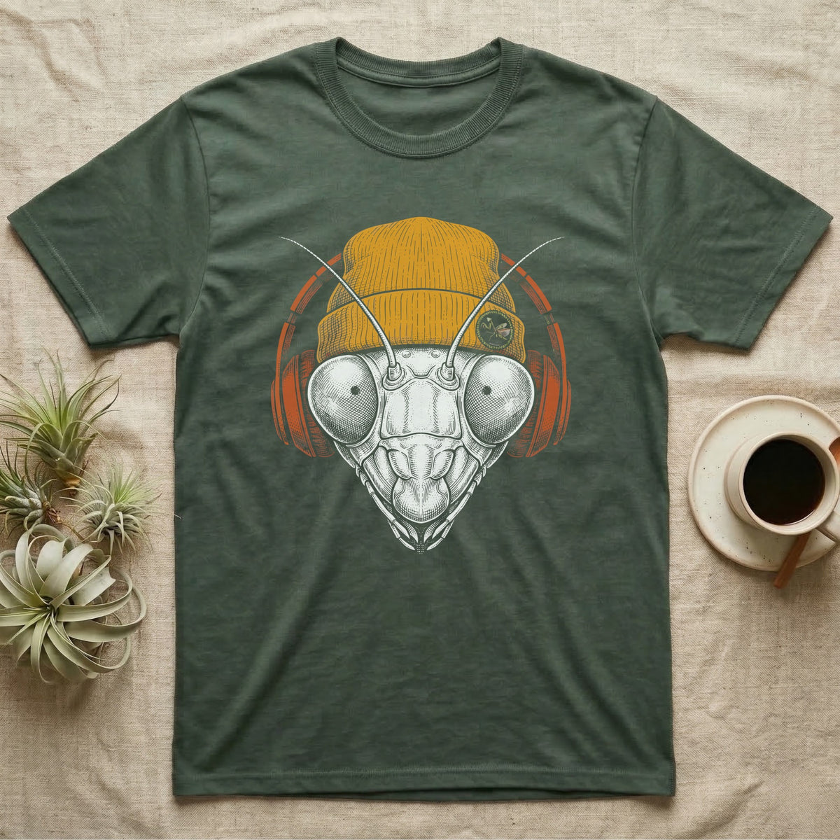 Praying Mantis Chill Beats T-Shirt in Military Green — Engraved praying mantis with large compound eyes and antennae, wearing a knit beanie and over-ear headphones.