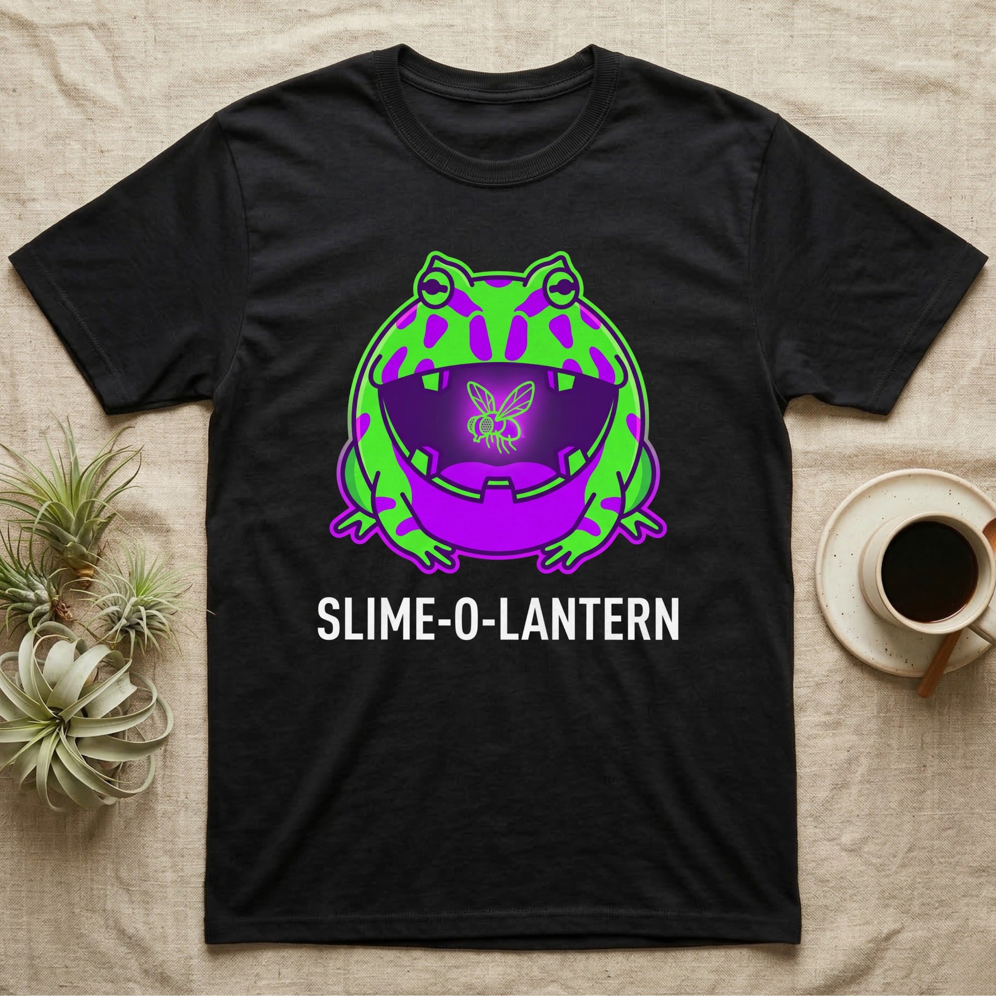 Pacman Frog Slime-O-Lantern T-Shirt in Black — Neon pop-art Pacman frog shaped like a jack-o'-lantern with a lit fly in its mouth, "Slime-O-Lantern."