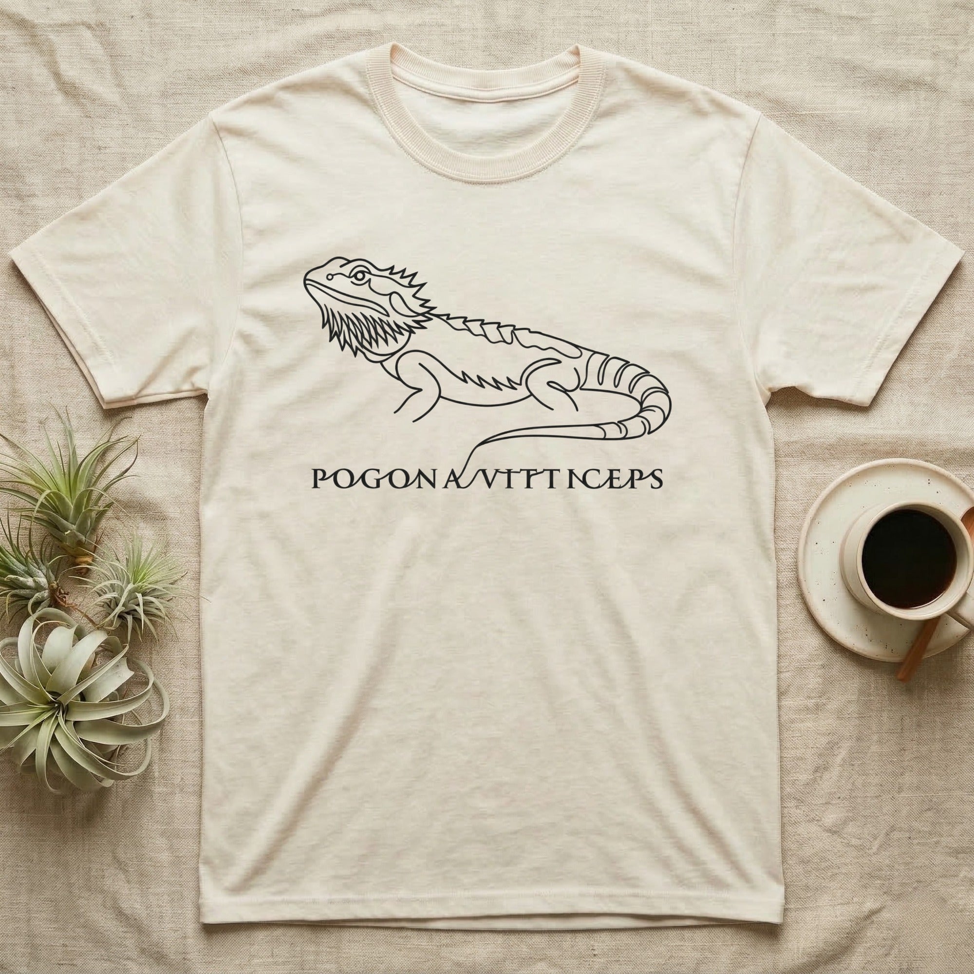 T-shirt with black line drawing of a bearded dragon and text.