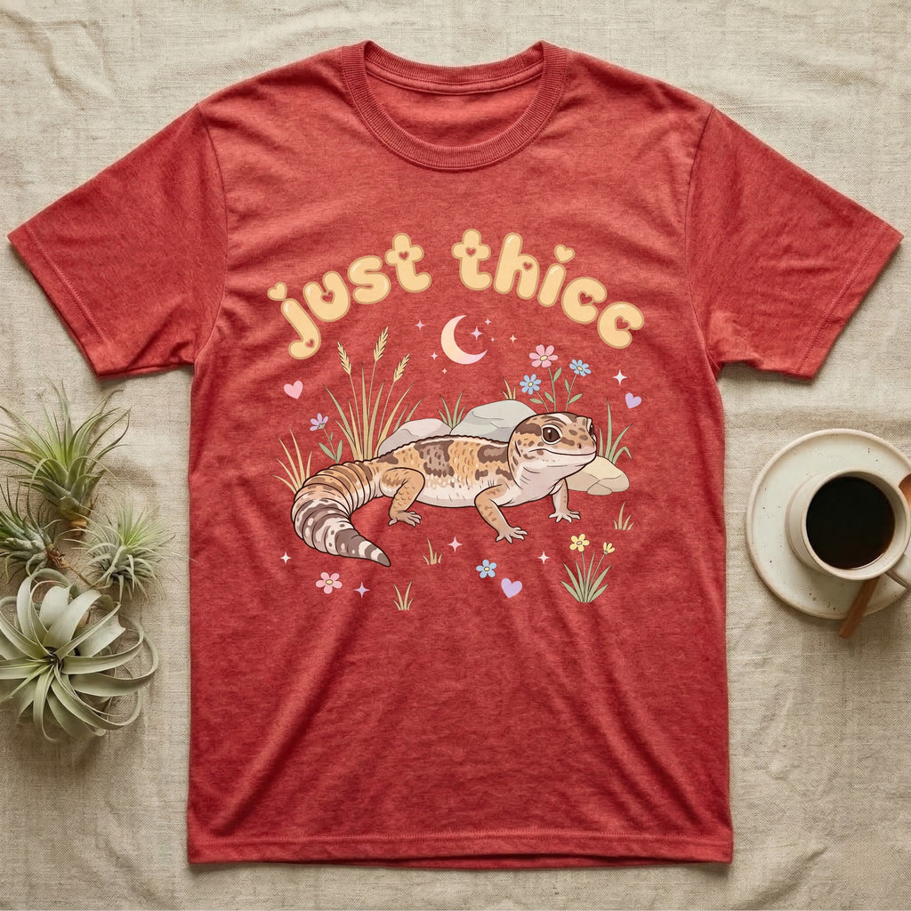 African Fat-Tailed Gecko Softie T-Shirt in Heather Red — African fat-tailed gecko with a plump tail under a puffy pastel "just thicc" bubble wordmark with tiny hearts.