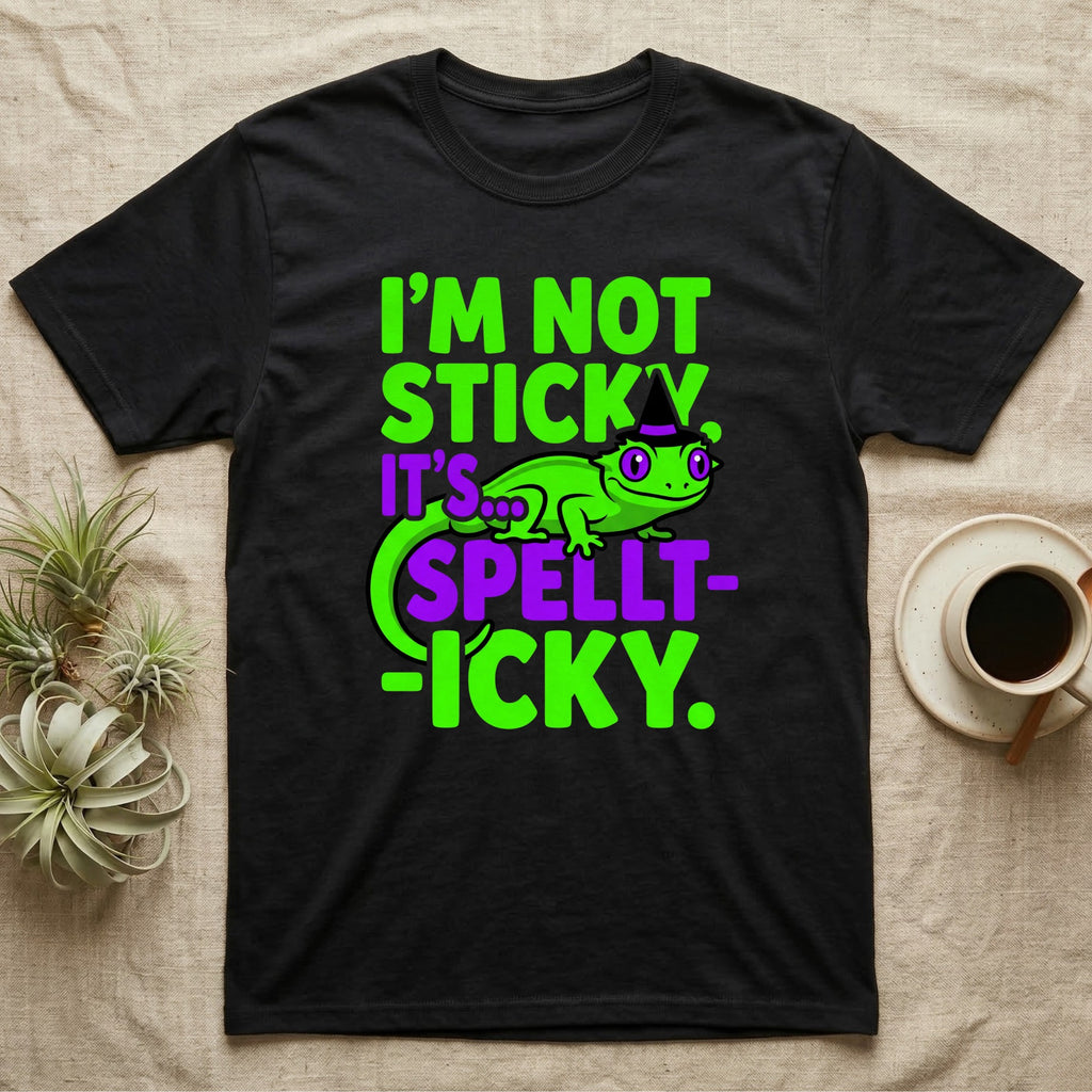 Crested Gecko Spellt-icky T-Shirt in Black — Neon cartoon crested gecko in a witch hat with stacked text, "I'm Not Sticky, It's Spellt-icky."