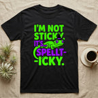 Crested Gecko Spellt-icky T-Shirt in Black — Neon cartoon crested gecko in a witch hat with stacked text, "I'm Not Sticky, It's Spellt-icky."