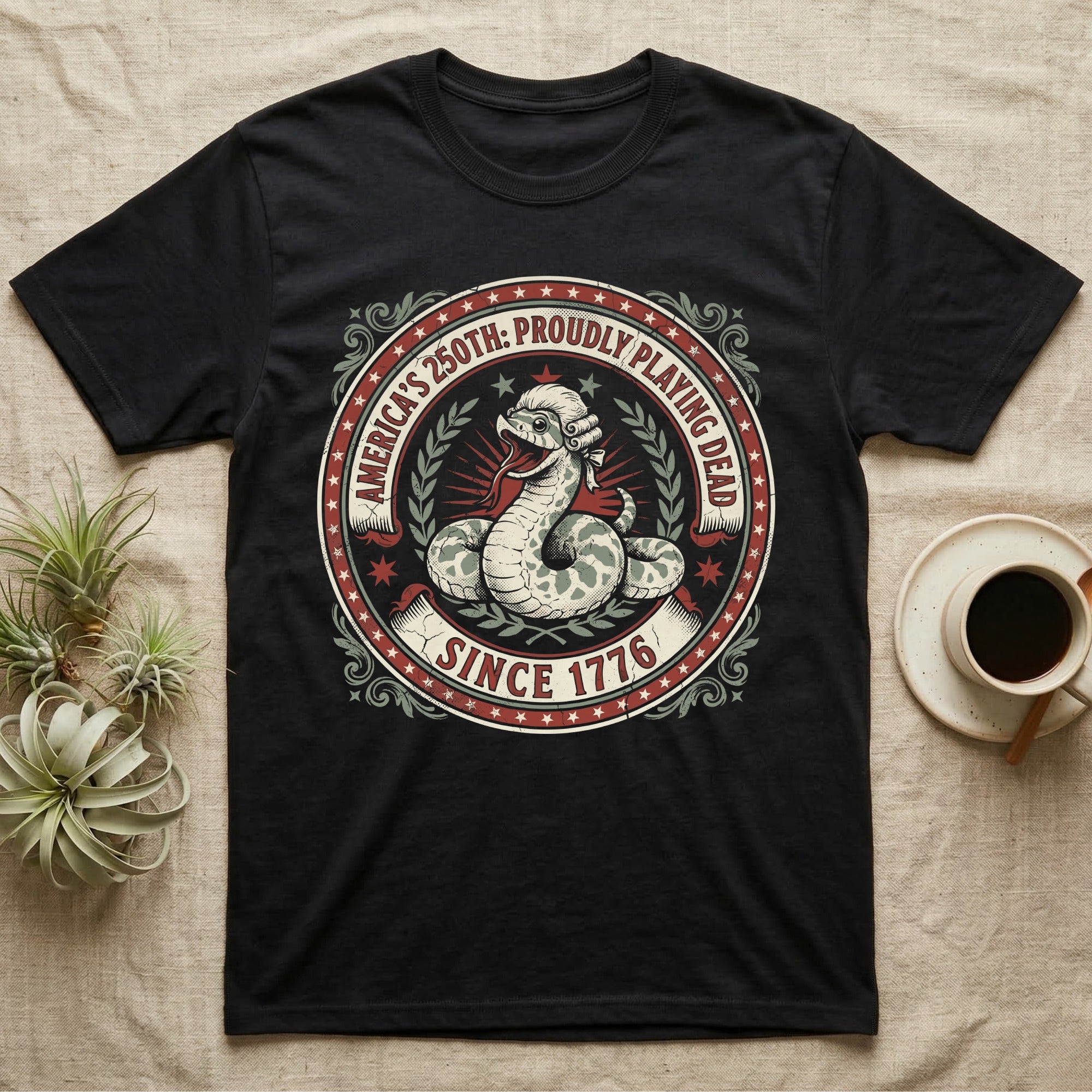 Hognose Snake 1776 Tee in Black — Vintage circular seal of a hognose snake playing dead belly-up in a colonial wig, brick-red and cream emblem reading Proudly Playing Dead Since 1776.