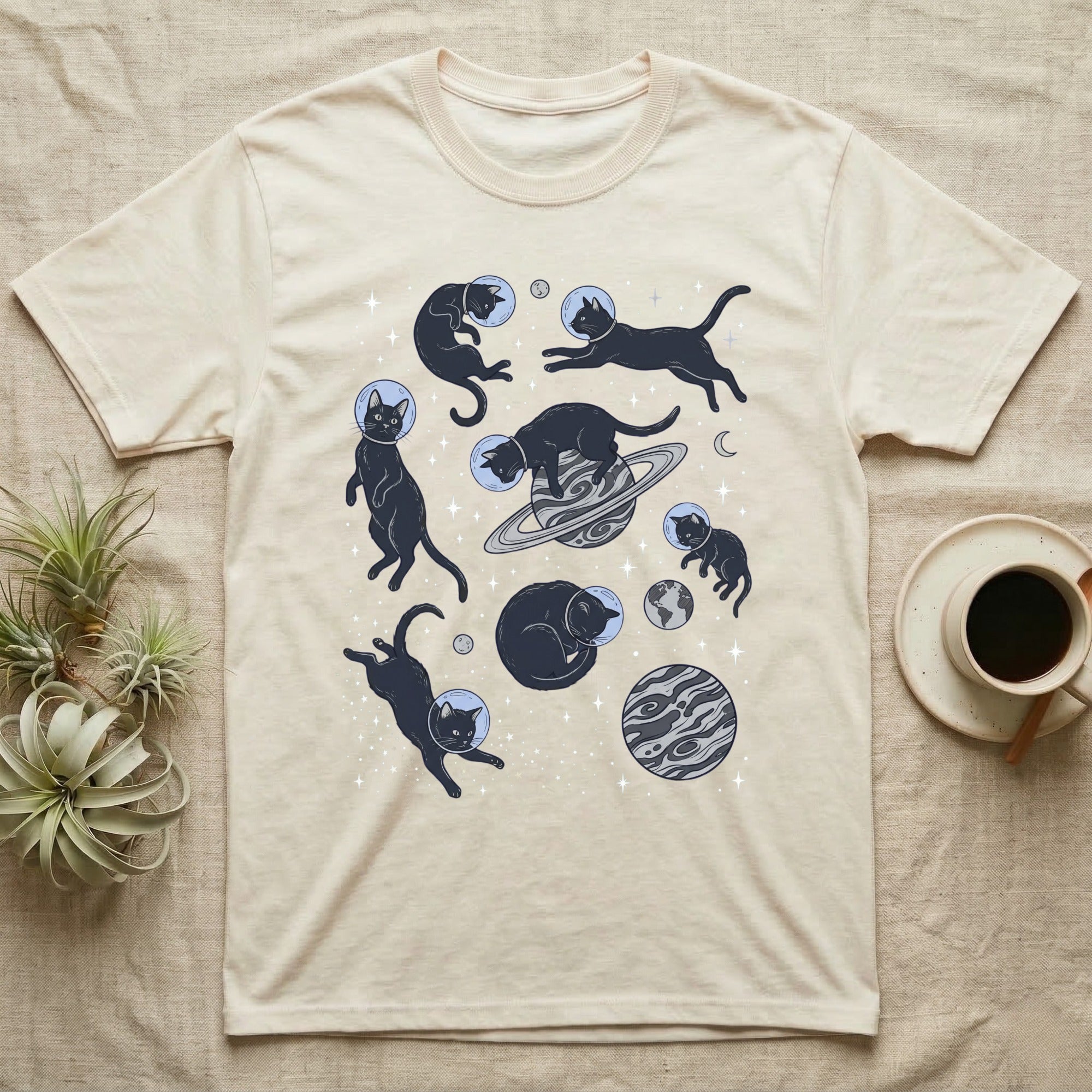 Cream t-shirt with playful black cats in space.