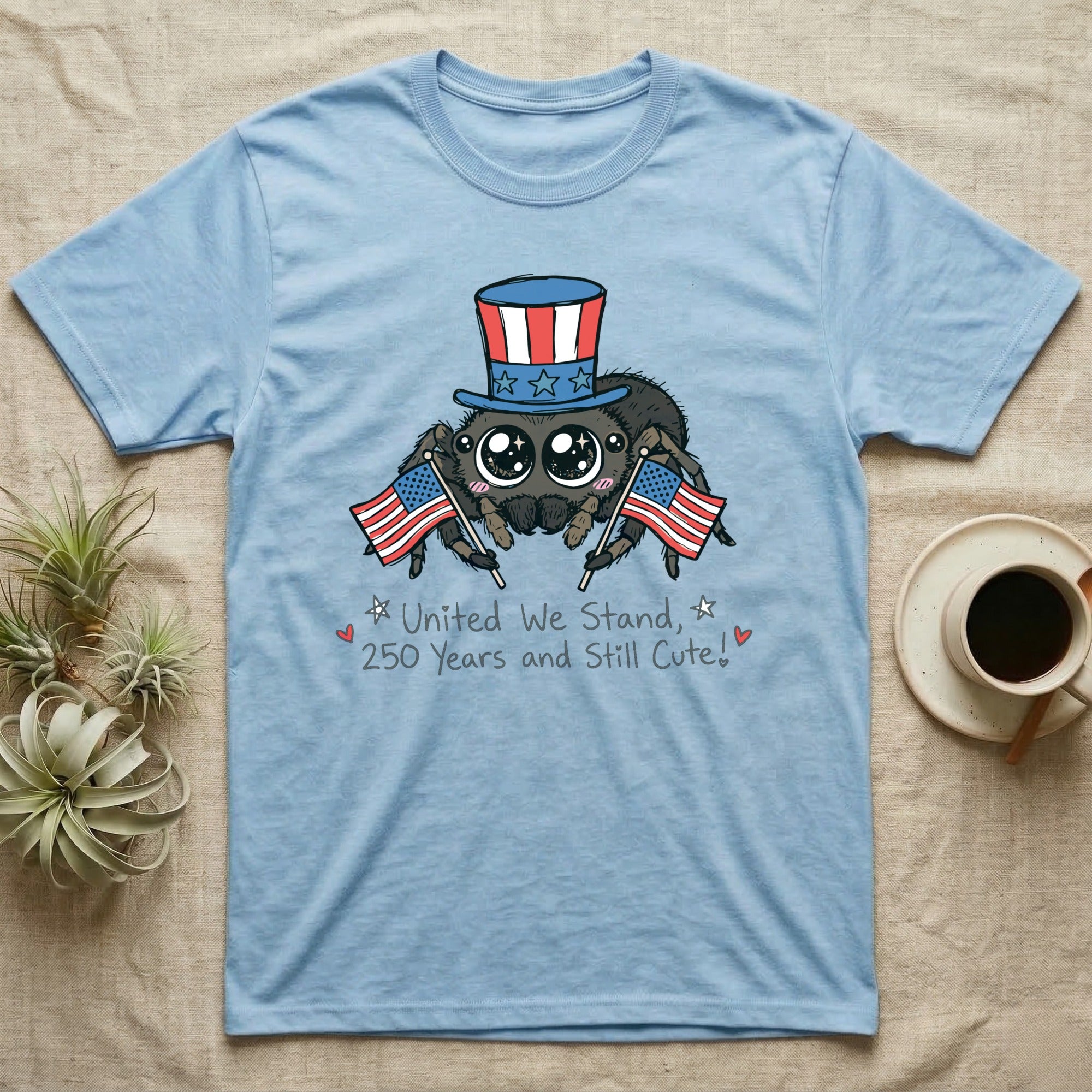 Jumping Spider Cute T-Shirt in Light Blue — Kawaii jumping spider with big eyes in a top hat waving two flags above script United We Stand, 250 Years and Still Cute.