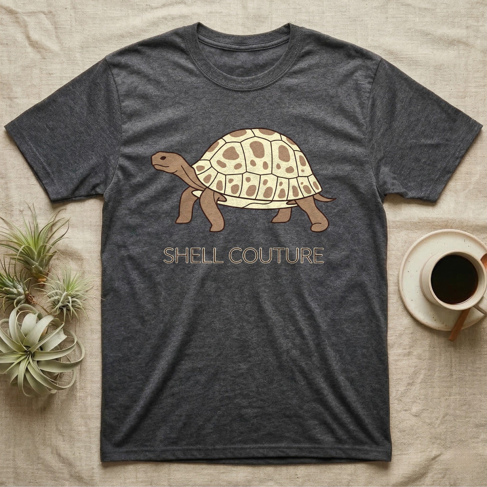 Dark grey t-shirt with a tortoise graphic and "SHELL COUTURE" text.