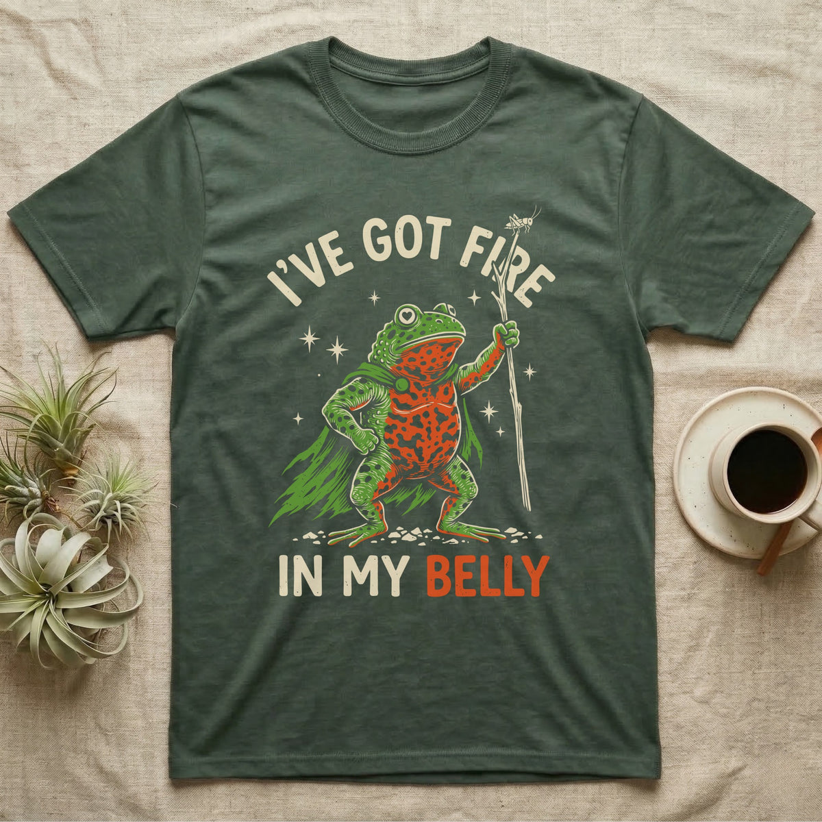 Fire-Bellied Toad Knight T-Shirt in Military Green — Fire-bellied toad knight with green cape, orange belly and a cricket on a twig spear, lettered I'VE GOT FIRE IN MY BELLY