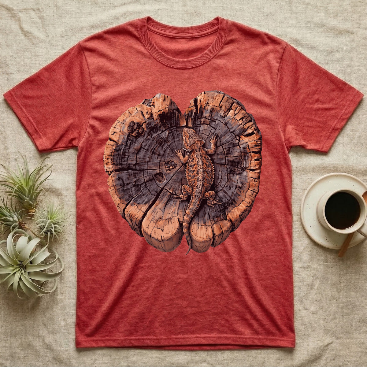 Bearded Dragon Basking Rings T-Shirt in Heather Red — Top-down illustration of a bearded dragon splayed flat on a cross-section log slab of terracotta growth rings with bracket fungus, no on-shirt text.