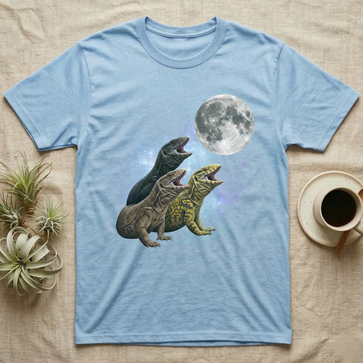 Savannah Monitor Moon Howl T-Shirt in Light Blue — Three Savannah Monitor colour morphs howling at a full moon over a nebula on a dark grey t-shirt.