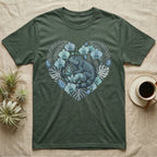Green t-shirt with a heart design featuring a lizard and tropical leaves.