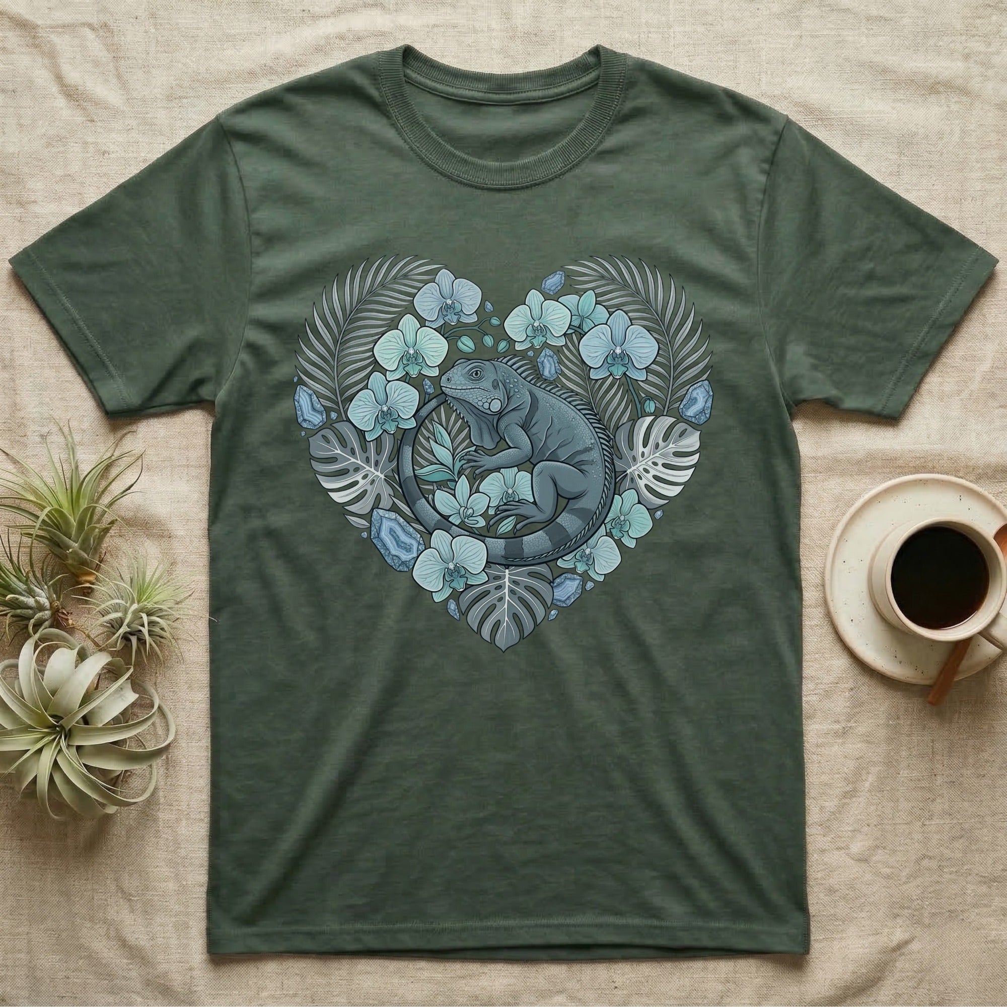 Green t-shirt with a heart design featuring a lizard and tropical leaves.