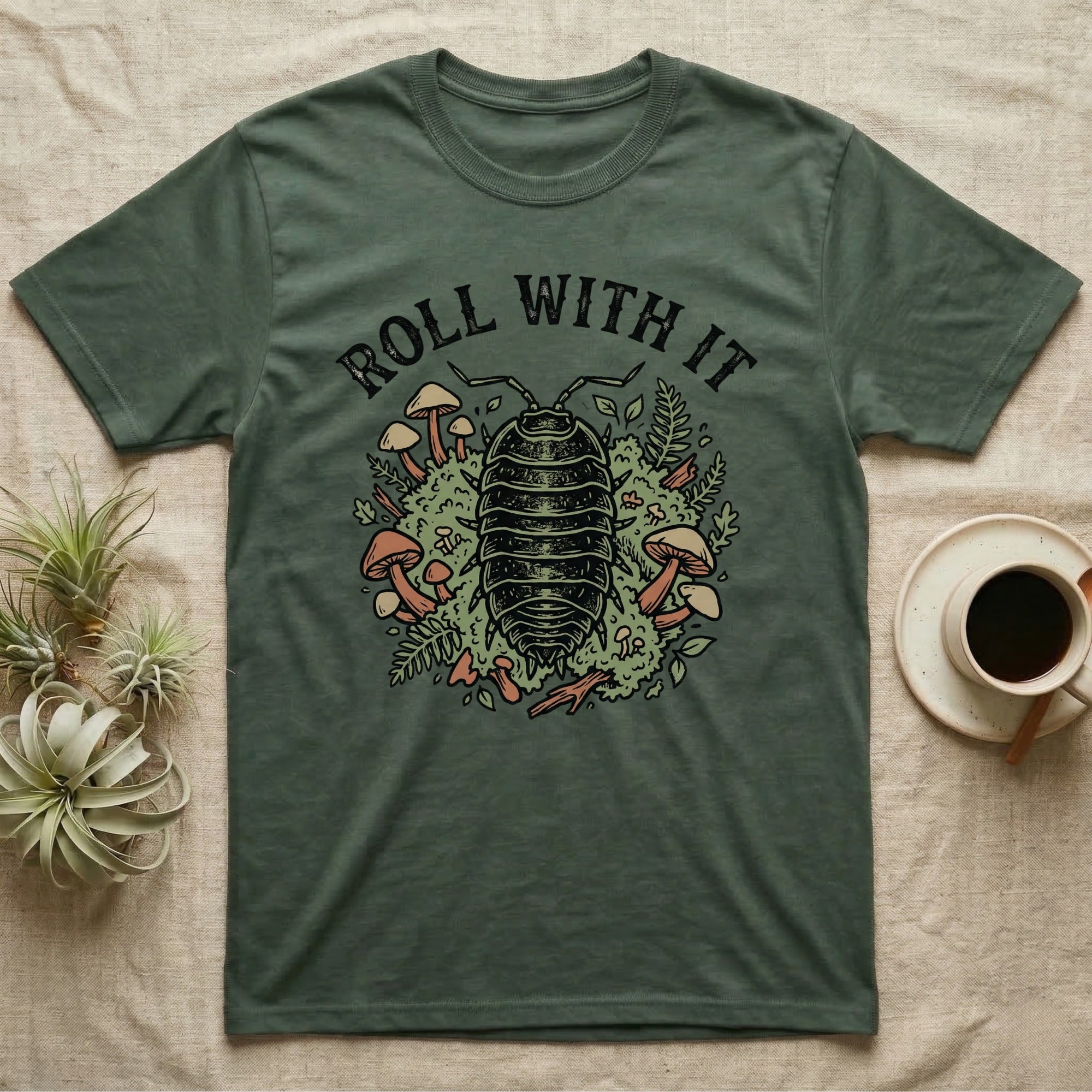 T-shirt with a detailed illustration of an isopod surrounded by mushrooms and foliage.