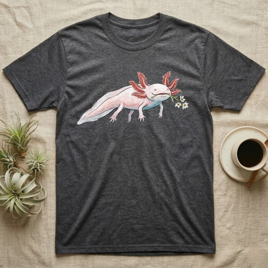 Axolotl Blossom T-Shirt in Dark Heather — Watercolor illustration of a pink leucistic axolotl with feathery gills holding an aquatic blossom sprig, on a dark grey t-shirt.