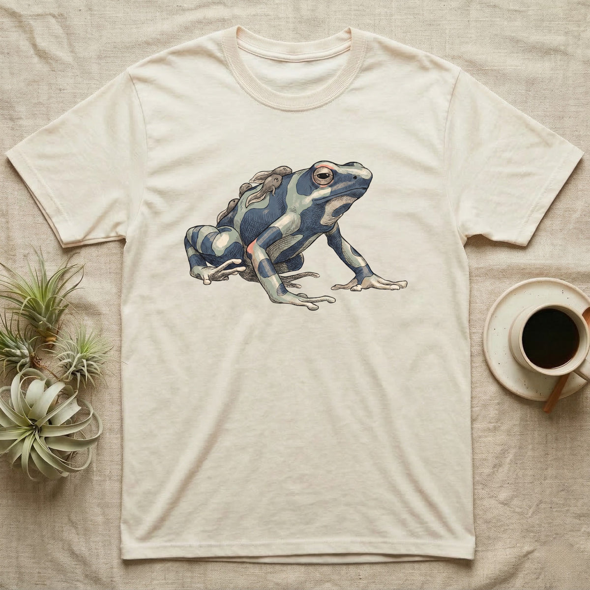 Dart Frog Tadpole T-Shirt in Natural — Naturalist-plate illustration of a dyeing dart frog carrying tadpoles on its back with a dry typewriter caption beside it.