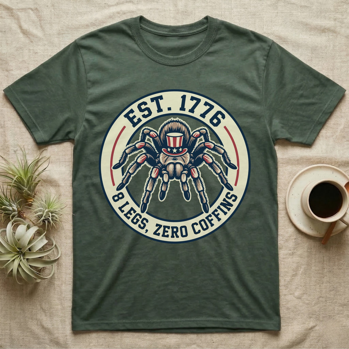 Tarantula Zero Coffins T-Shirt in Military Green — Circular patch emblem of a tarantula in a top hat with arched text Est. 1776 and 8 Legs Zero Coffins.