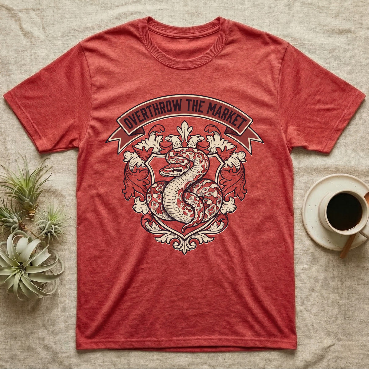 Overthrow The Market Python T-Shirt in Heather Red — Vintage heraldic-crest illustration of a regal ball python with a banner reading "Overthrow The Market."