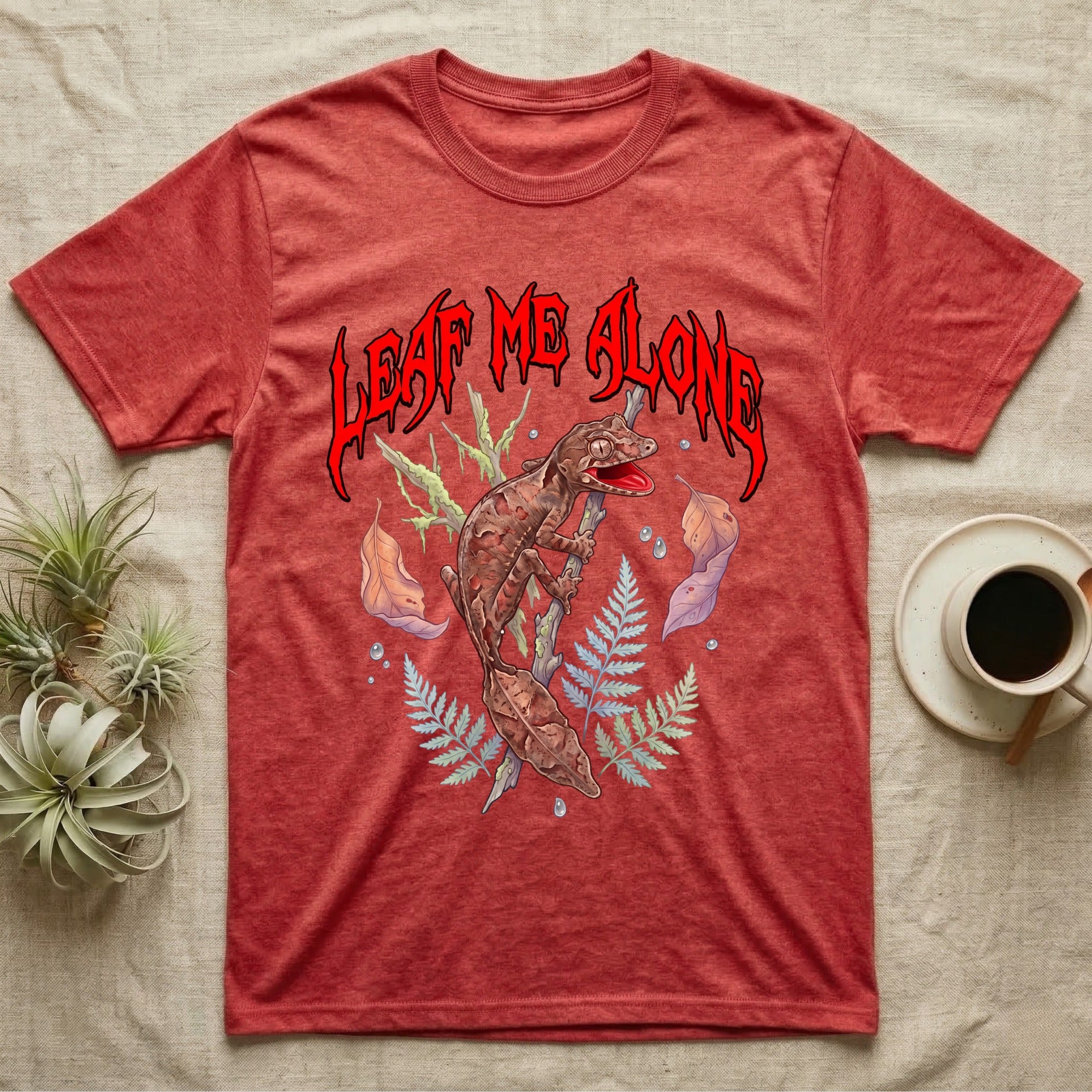 Satanic Leaf-Tailed Gecko Feral T-Shirt in Heather Red — Satanic leaf-tailed gecko gaping on a twig with dripping blood-red metal "Leaf Me Alone" wordmark above
