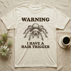 Tarantula Hair Trigger T-Shirt in Natural — Engraved curly hair tarantula, front legs half-raised, with the words Warning, I Have a Hair Trigger