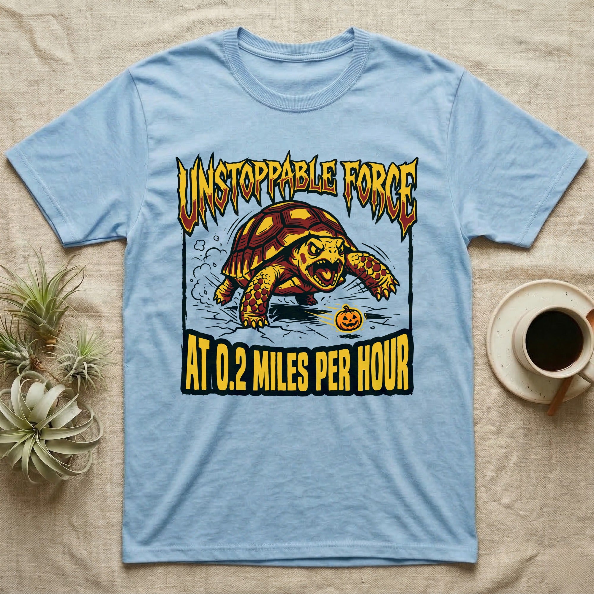 Red-Footed Tortoise Unstoppable Force T-Shirt in Light Blue — Metal-style furious tortoise charging a candy pumpkin, "Unstoppable Force At 0.2 Miles Per Hour."