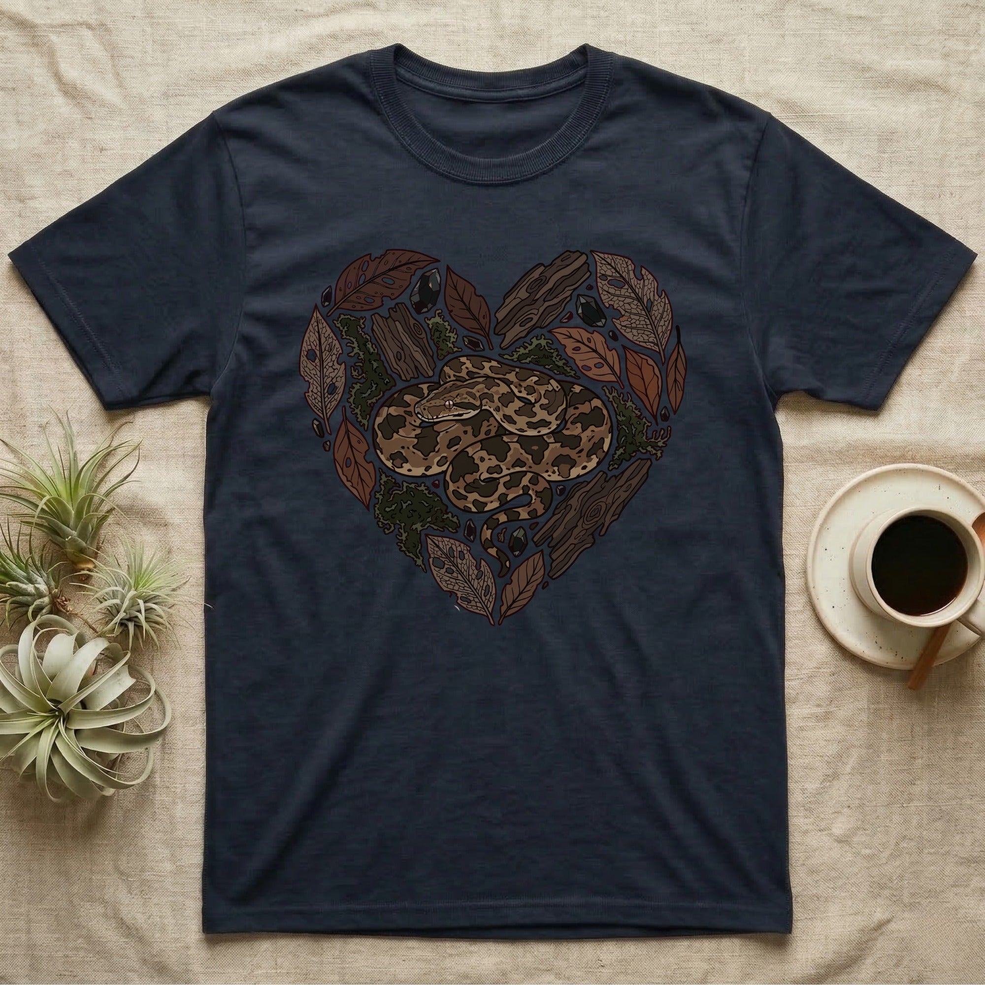 Dark t-shirt with a heart-shaped design of a snake and natural elements.