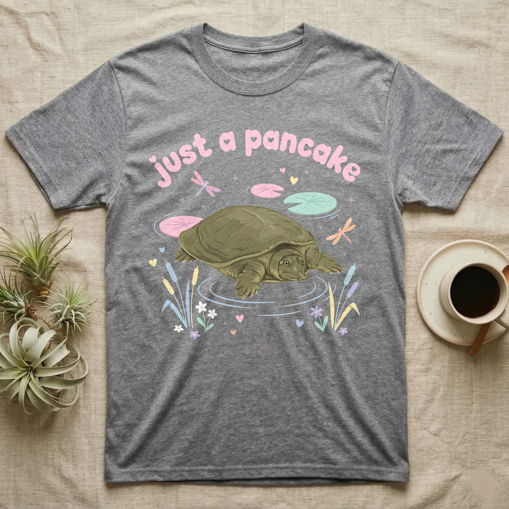 Spiny Softshell Turtle Baby T-Shirt in Sport Grey — Pastel spiny softshell turtle with flat shell and snorkel nose among lily pads, puffy pink wordmark "just a pancake" above.