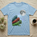 Green Iguana Moon Howl T-Shirt in Light Blue — Three Green Iguana colour morphs howling at a full moon over a nebula on a dark grey t-shirt.