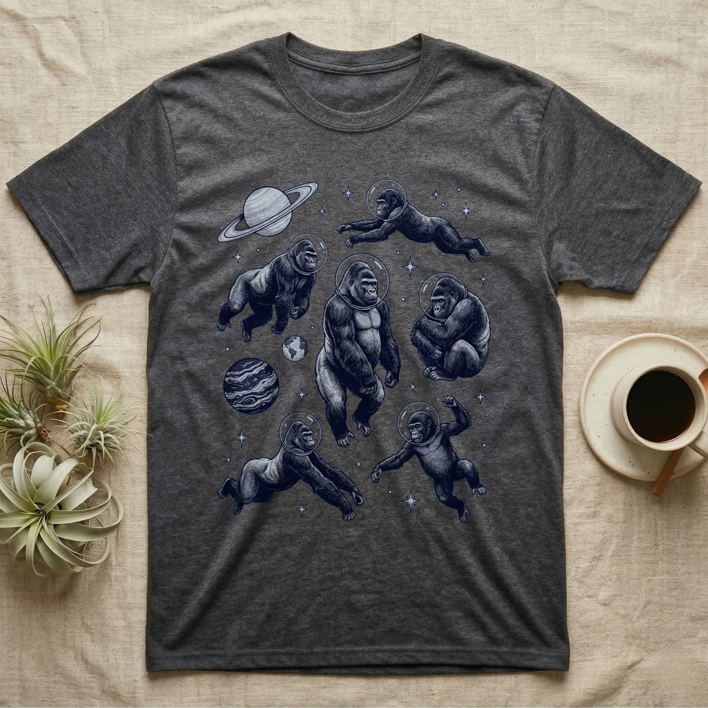 T-shirt with multiple cartoon gorillas in space outfits, planets, and stars.