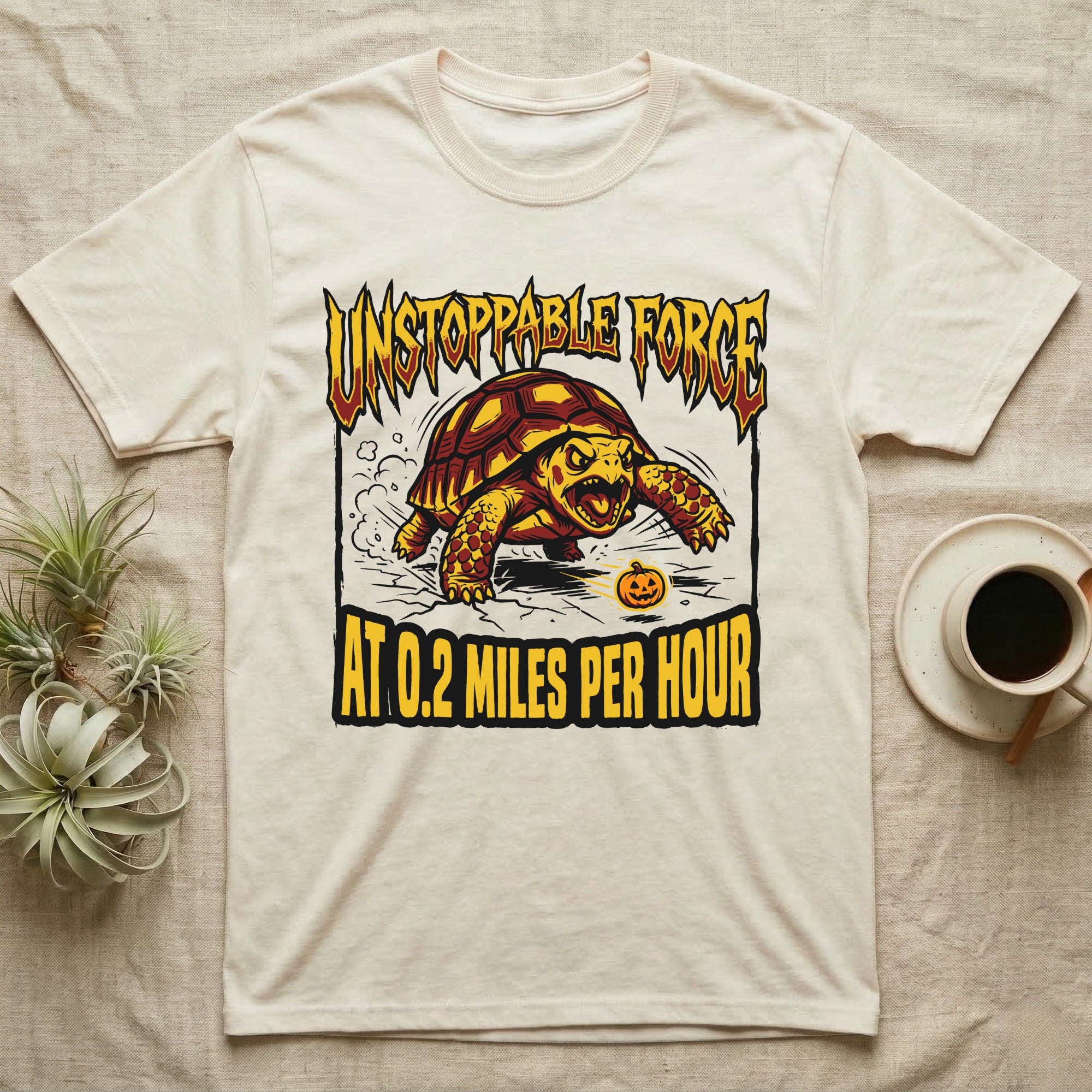 Red-Footed Tortoise Unstoppable Force T-Shirt in Natural — Metal-style furious tortoise charging a candy pumpkin, "Unstoppable Force At 0.2 Miles Per Hour."